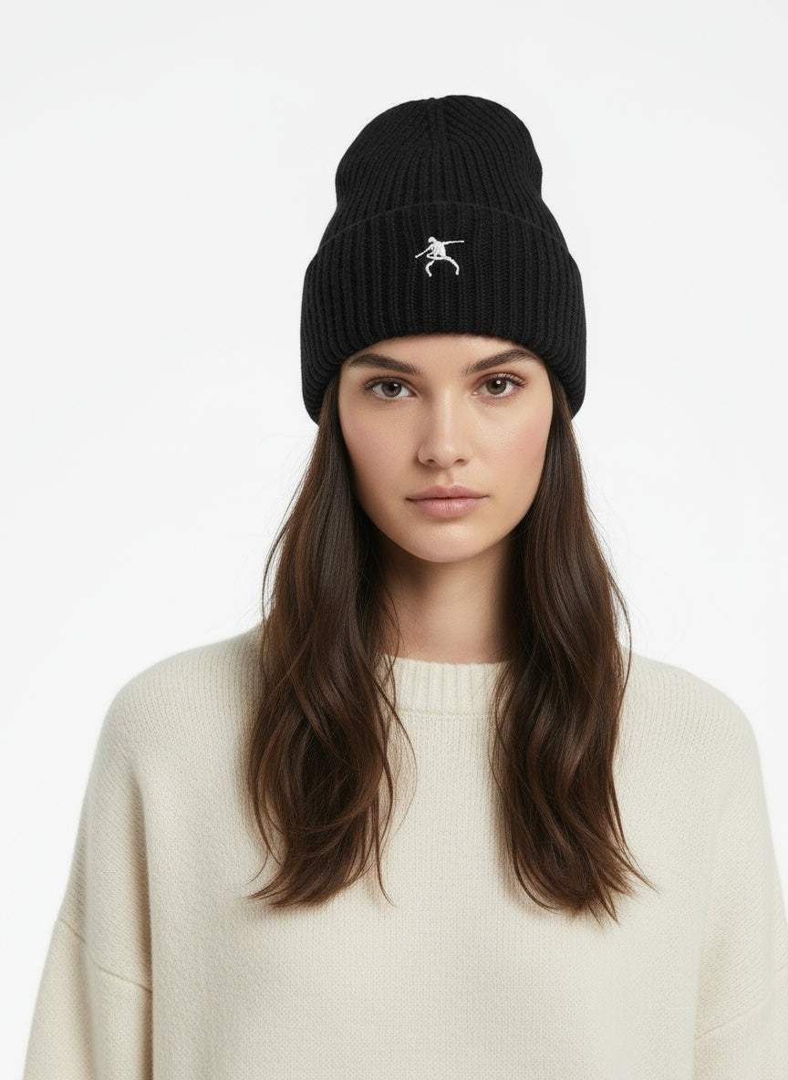 Close-up of the model wearing Sustainable Chunky Rib Knit Beanie- Black with white logo