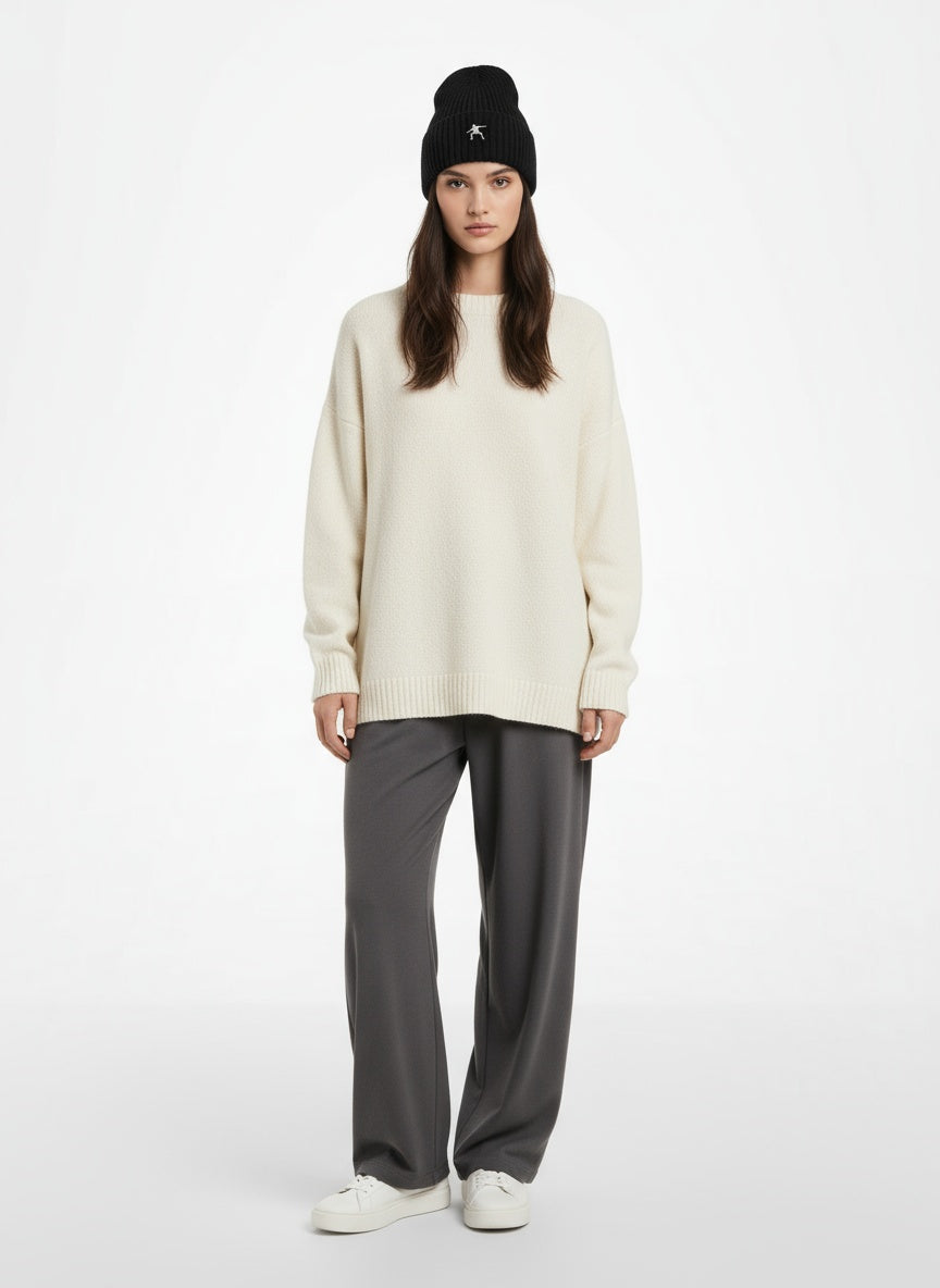 Full body view of the model wearing Sustainable Chunky Rib Knit Beanie- Black with white logo