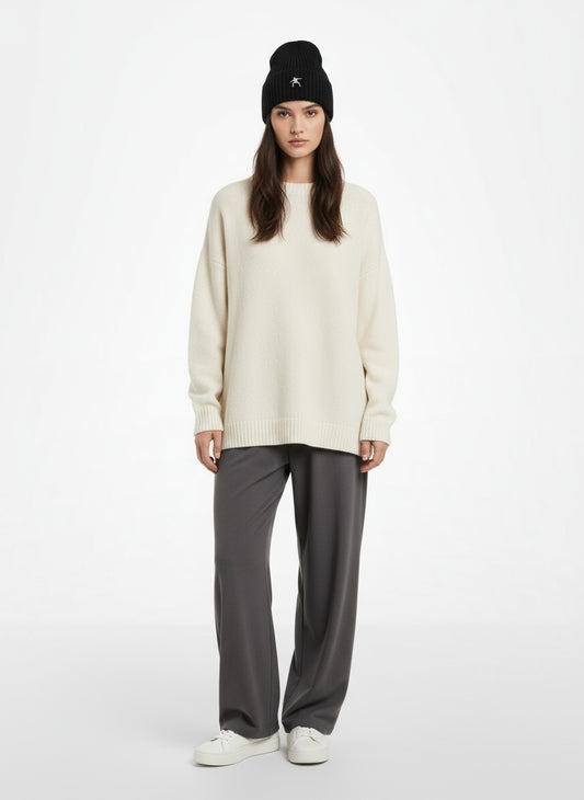 Full body view of the model wearing Sustainable Chunky Rib Knit Beanie- Black with white logo