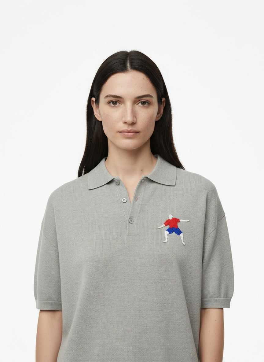 Close-up of the model wearing Adidas Performance Polo- Grey- white arms logo