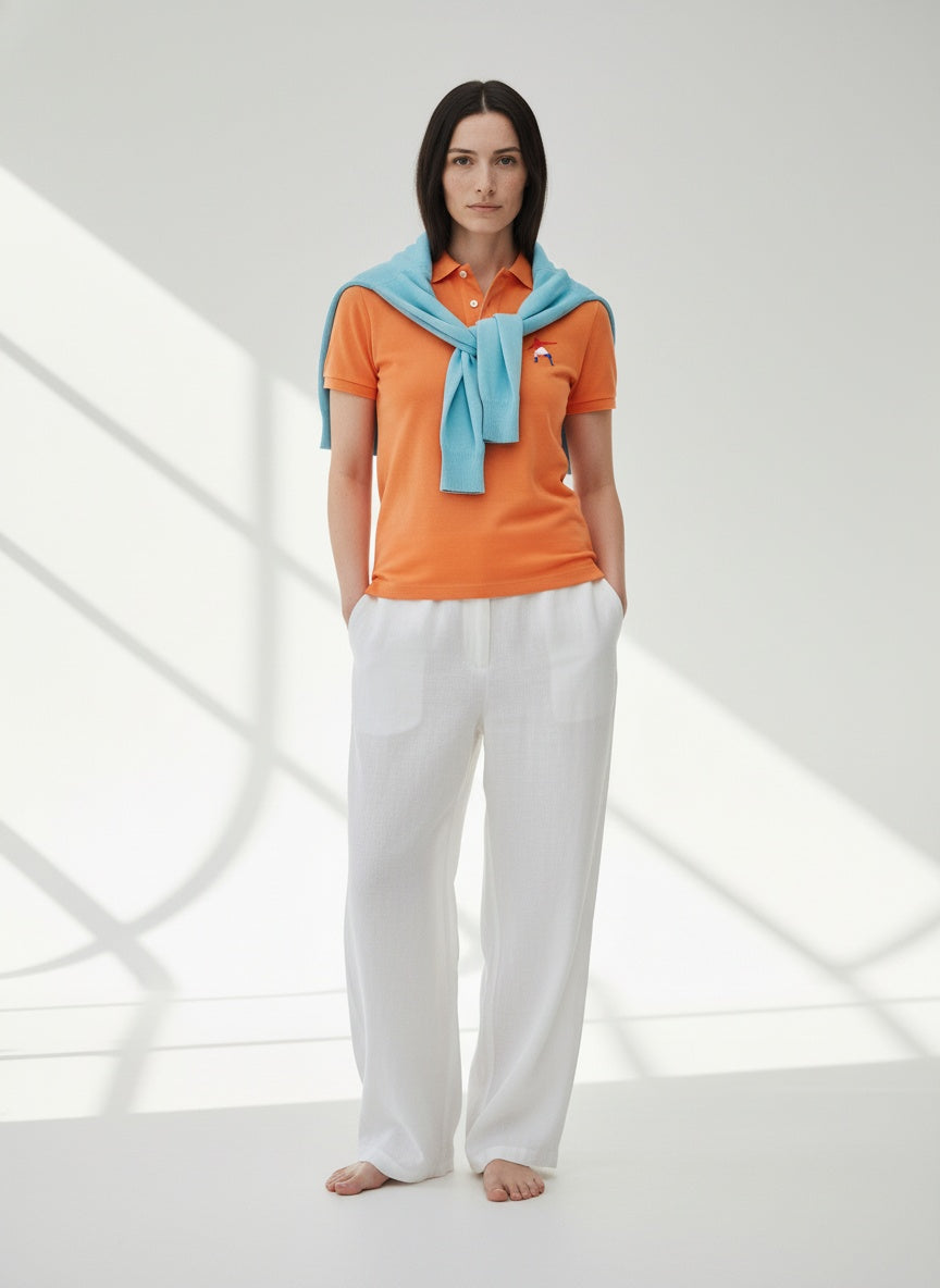 Full body view of the model wearing Nike dri-fit micro pique 2.0 polo- Orange