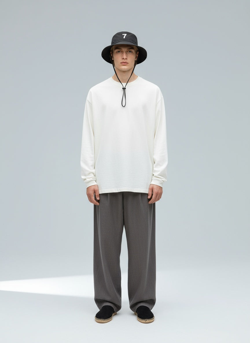 Full body view of the model wearing "7" Nylon Wide Brim Bucket Hat